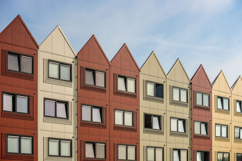 A vibrant row of gableroofed residential buildings with meta